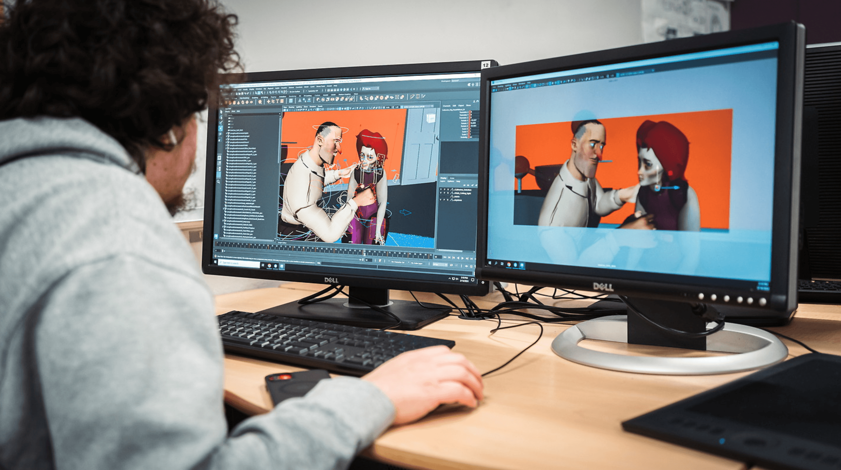 A person is using a dual-monitor computer setup to create and edit 3D animated characters, showcasing a detailed design interface with vibrant colors and complex textures.