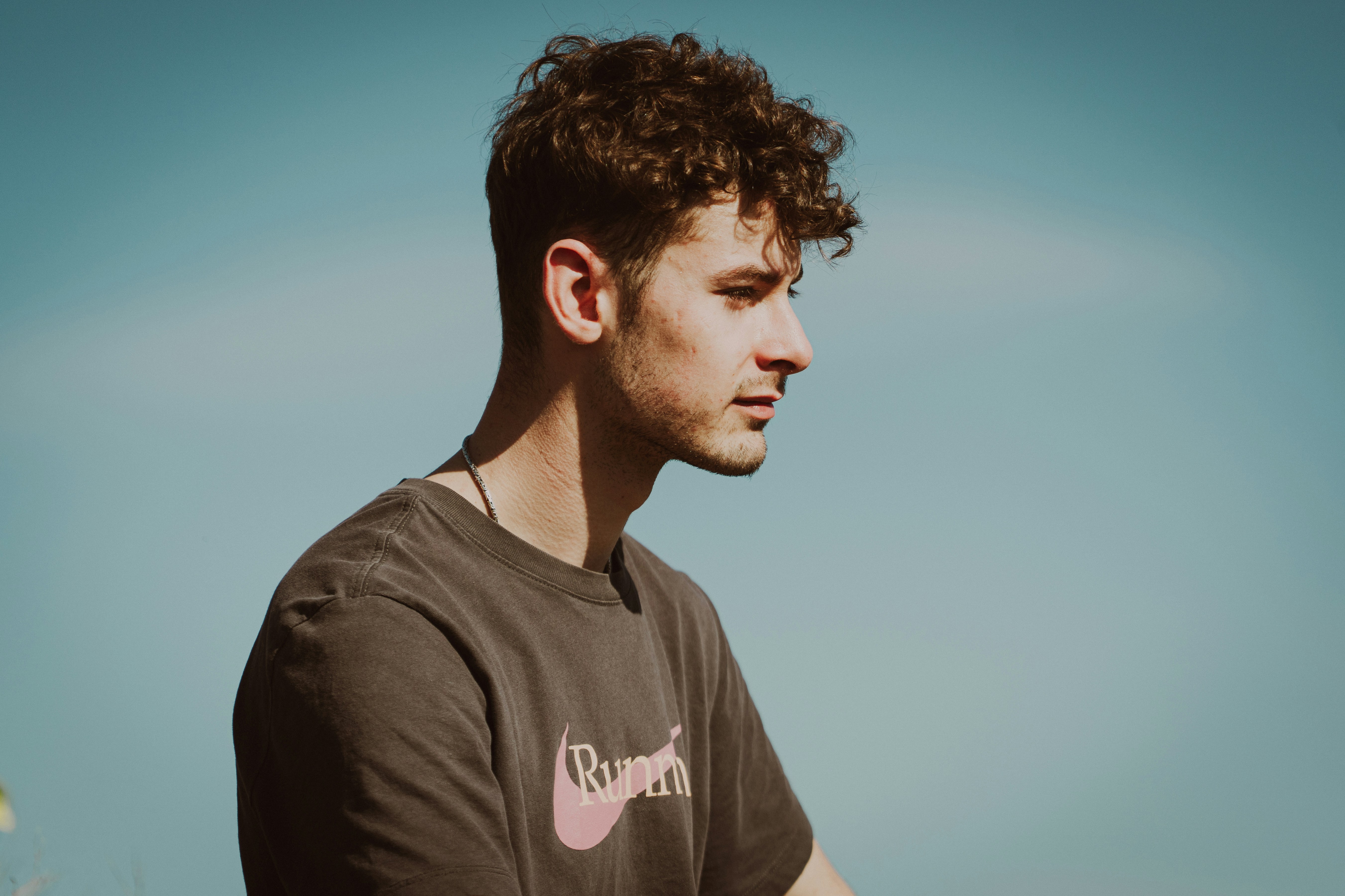 A man poses with the clear, blue sky.