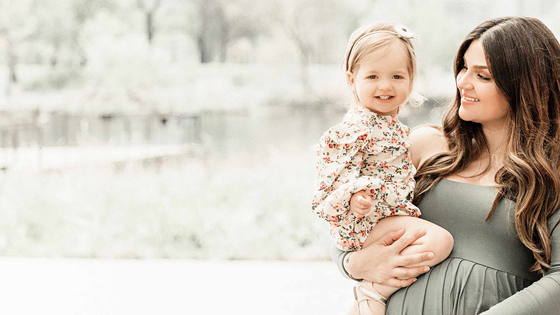 Maryam in green dress with her baby