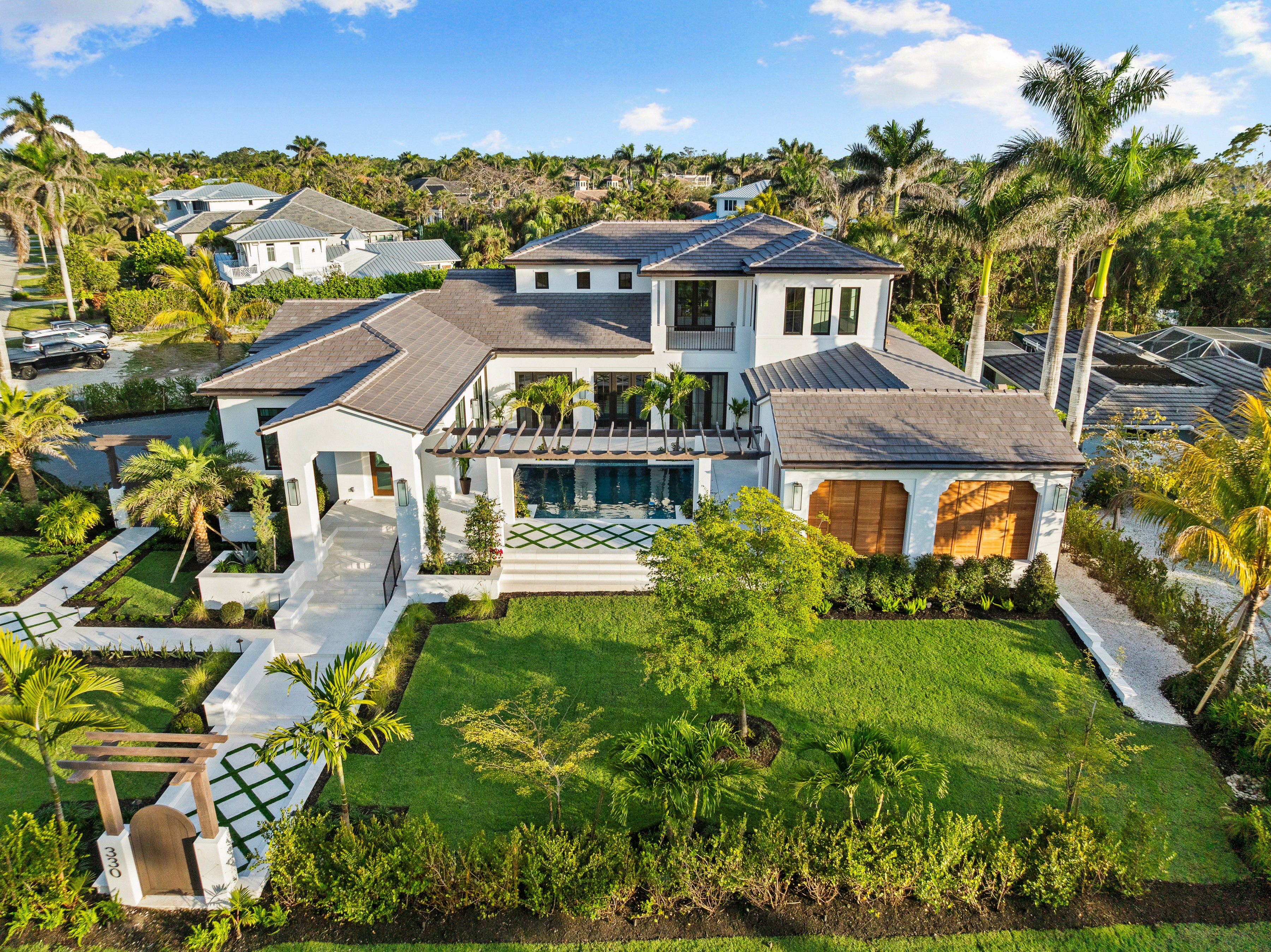 a sky down view of a west-indies inspired mansion