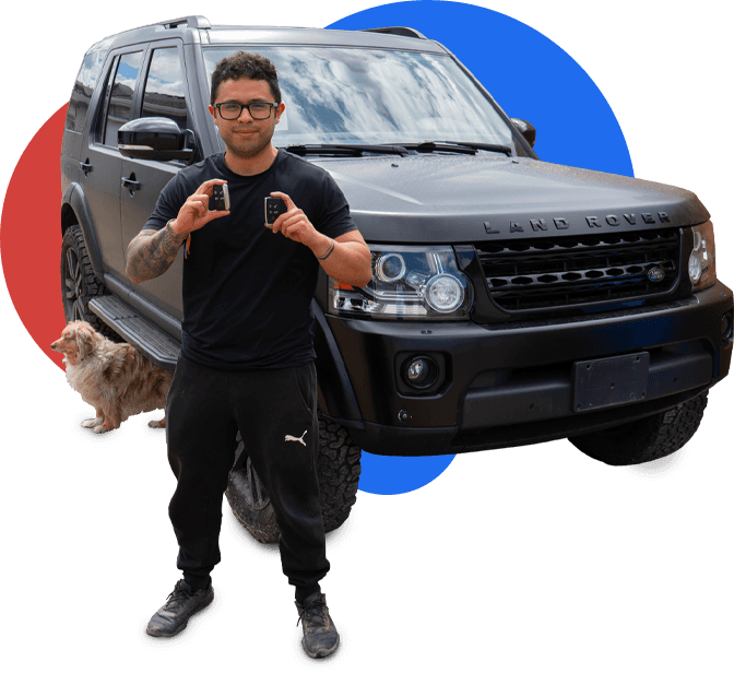 Happy CarKeyAction customer in Calgary holding newly made car keys while standing next to his vehicle