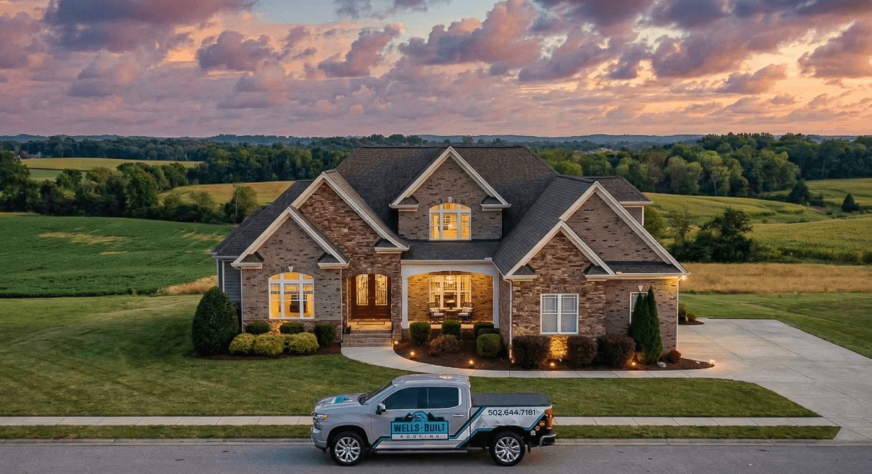 Wells Built Roofing truck parked in front of a brick home  during sunset hour