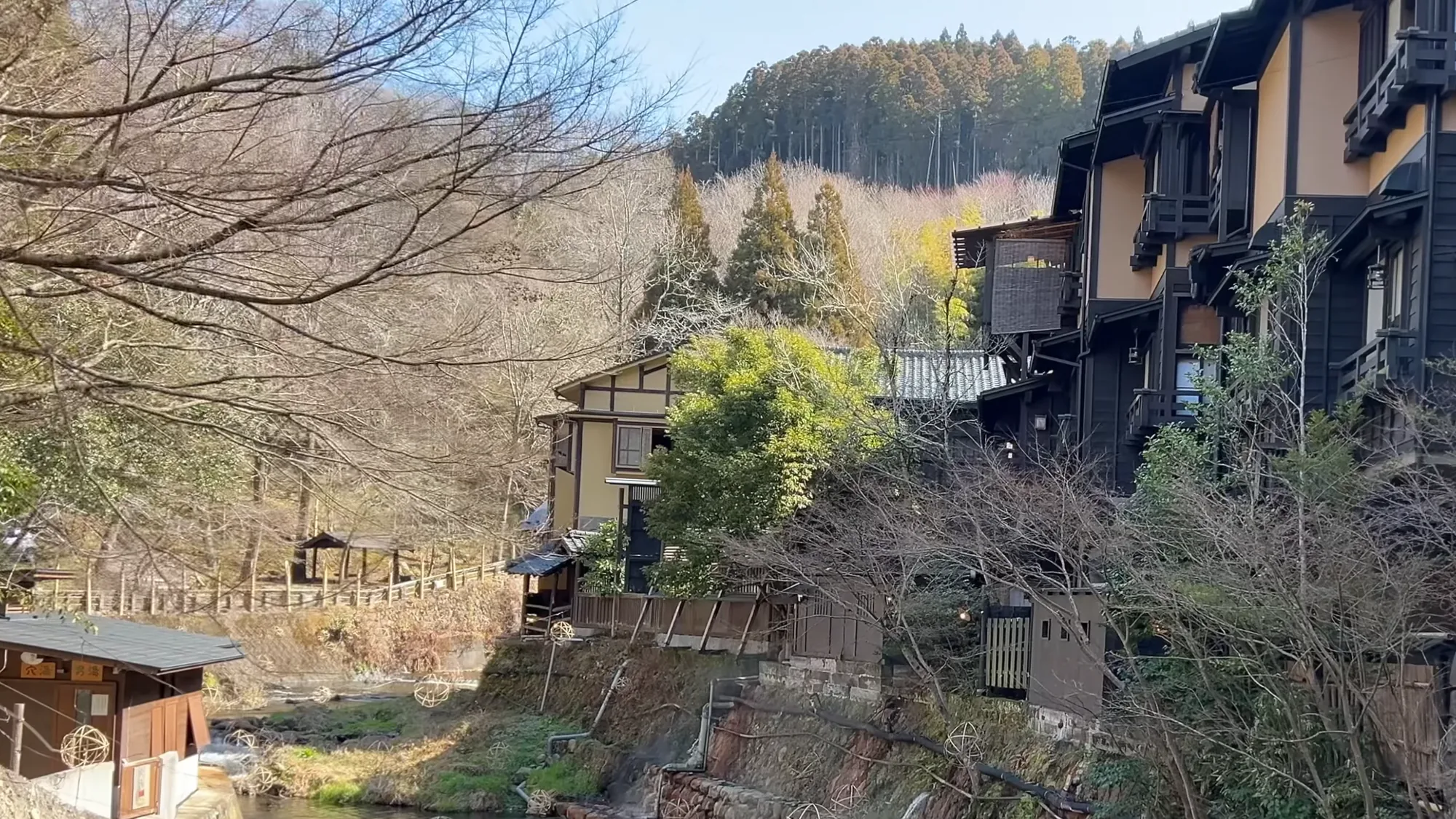 Inns above the river at Kurokawa Onsen in winter, seen from the bridge