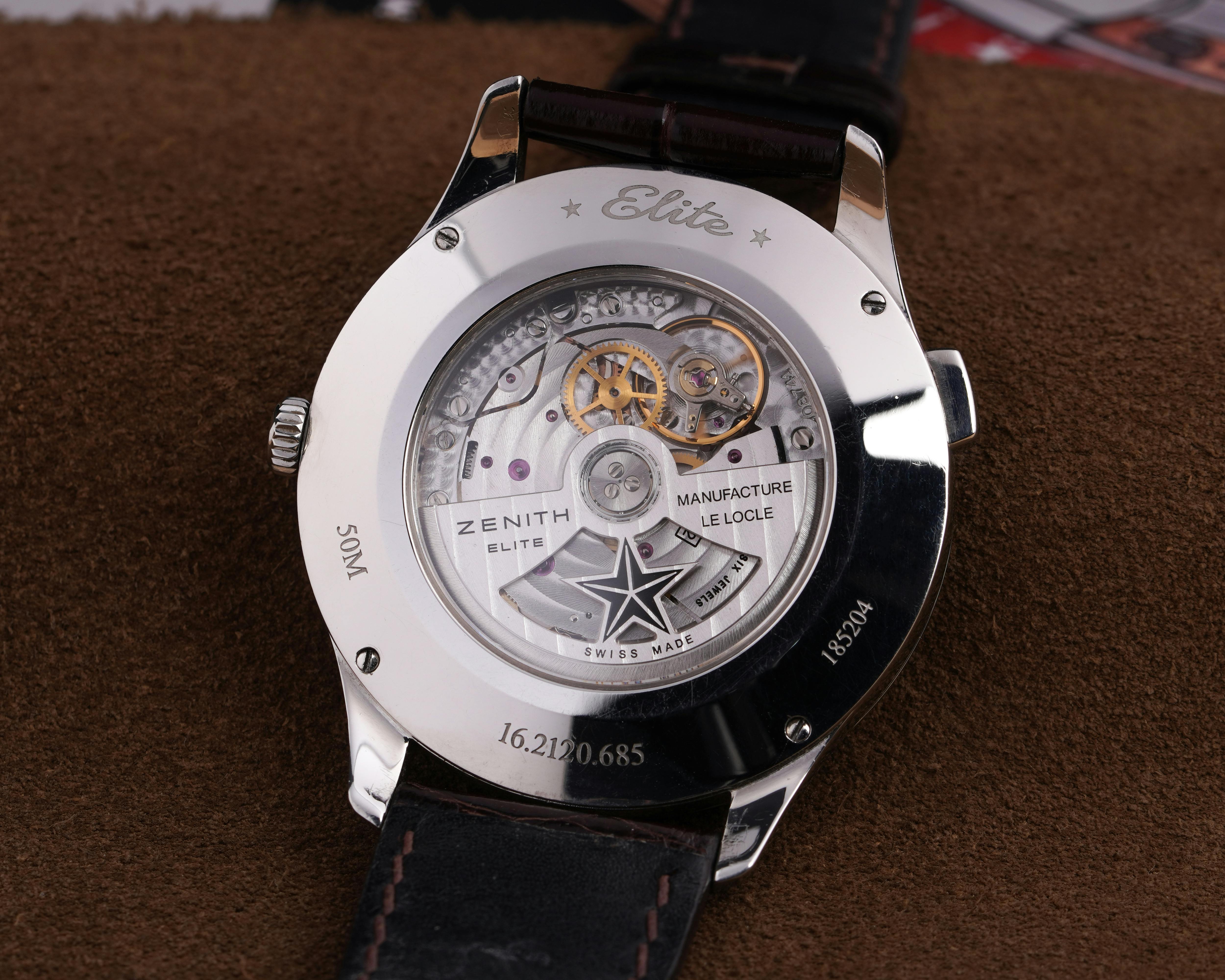 Zenith watch caseback showing rotor and automatic movement inside the case