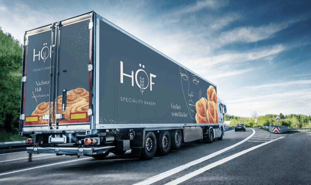 Hand holding black dropper bottle in silhouette