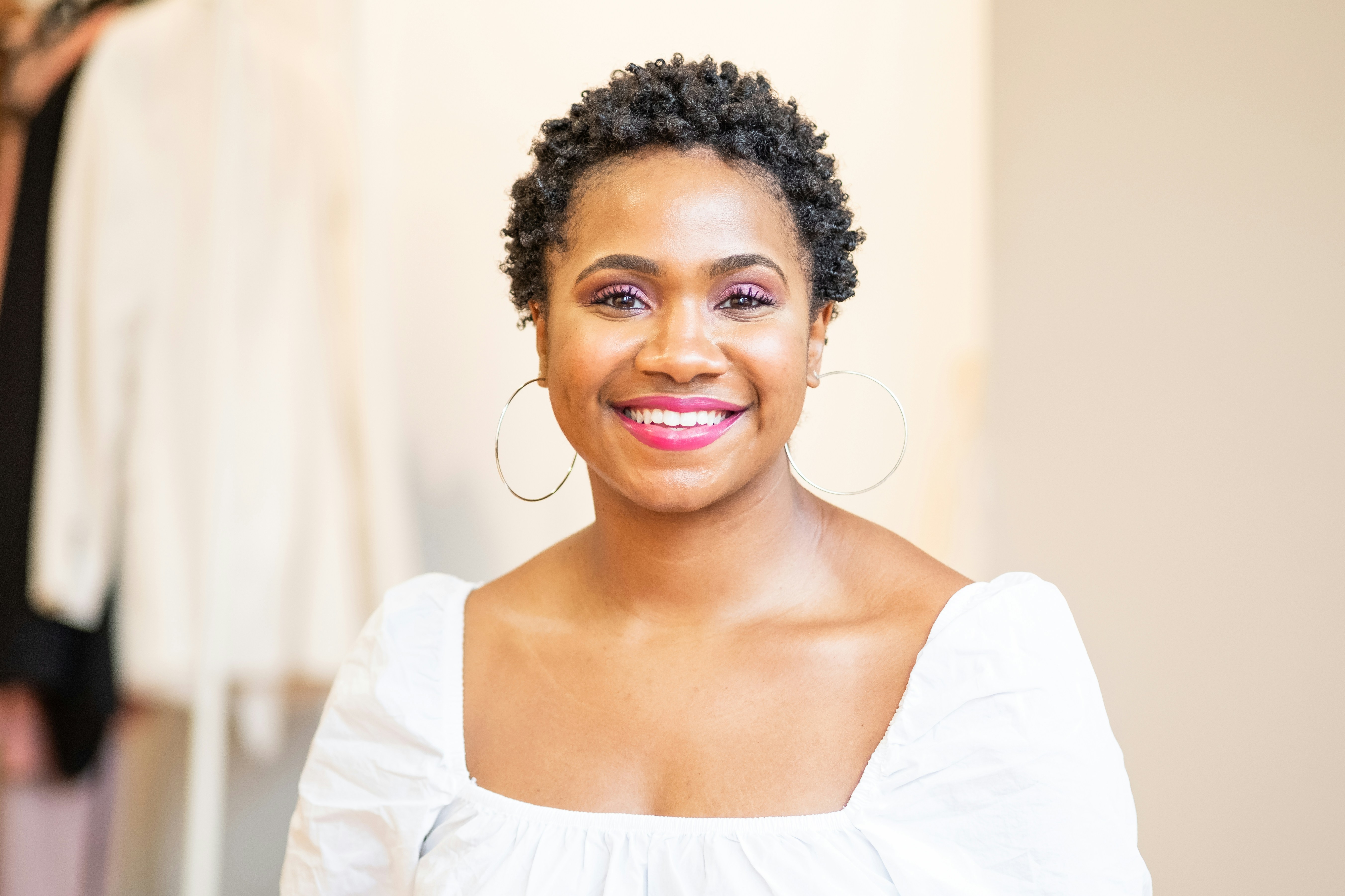 A woman posing with a warm approachable expression for a headshot