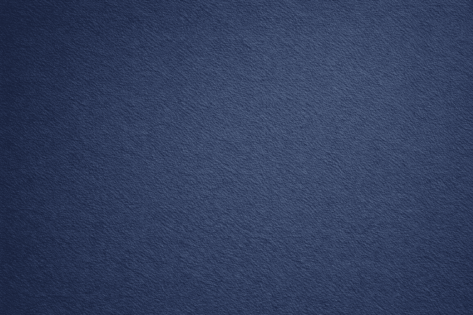 woman in blue tank top standing beside white wall