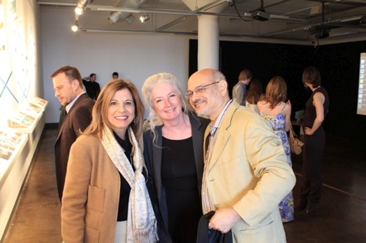 group photo of three people, two women and a man at the exhibition