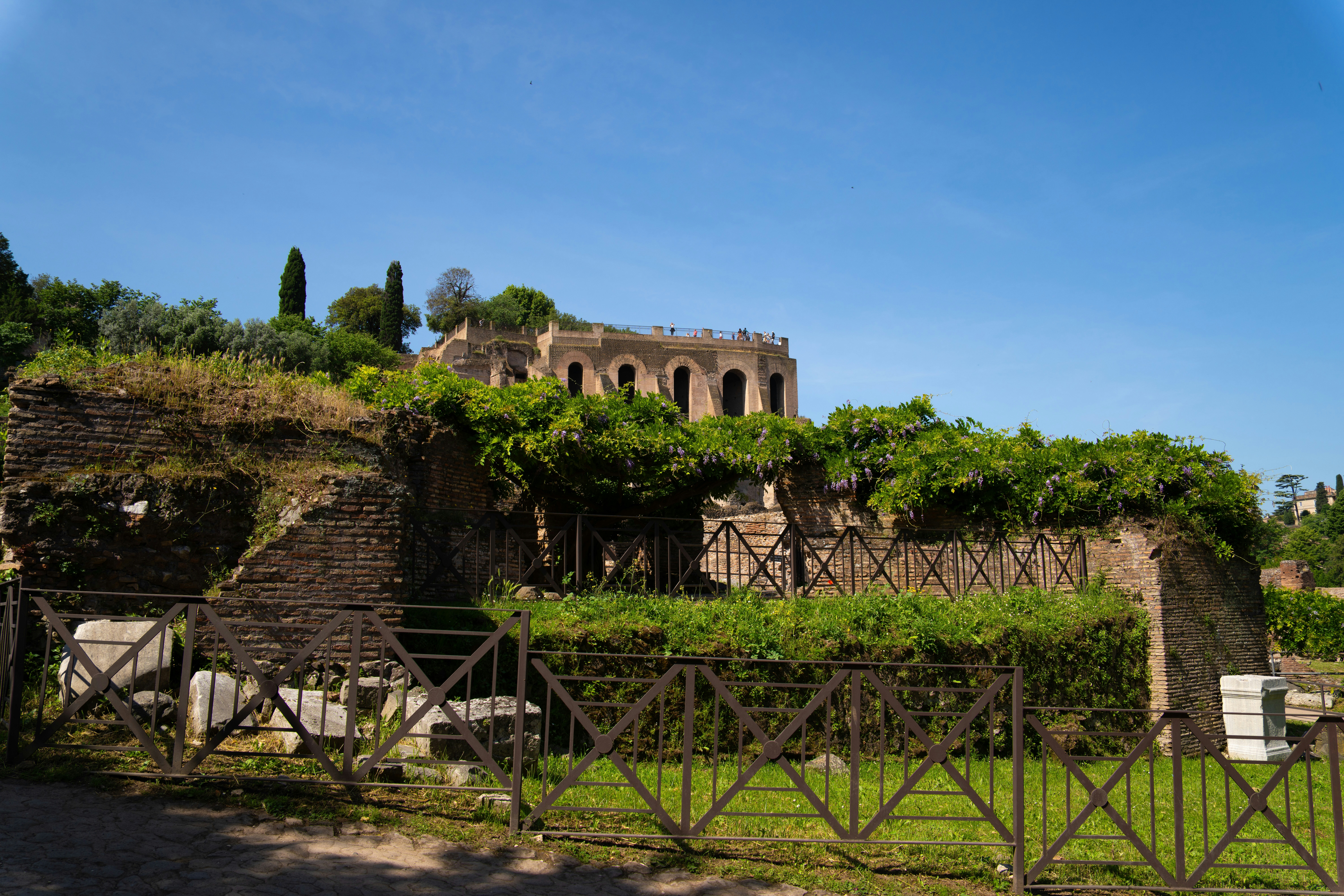 A stone building with vines growing over it