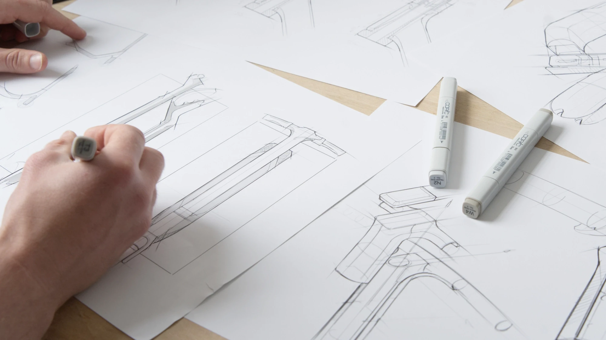 Industrial design concept sketches exploring form and technical details of a carbon fibre scooter frame.