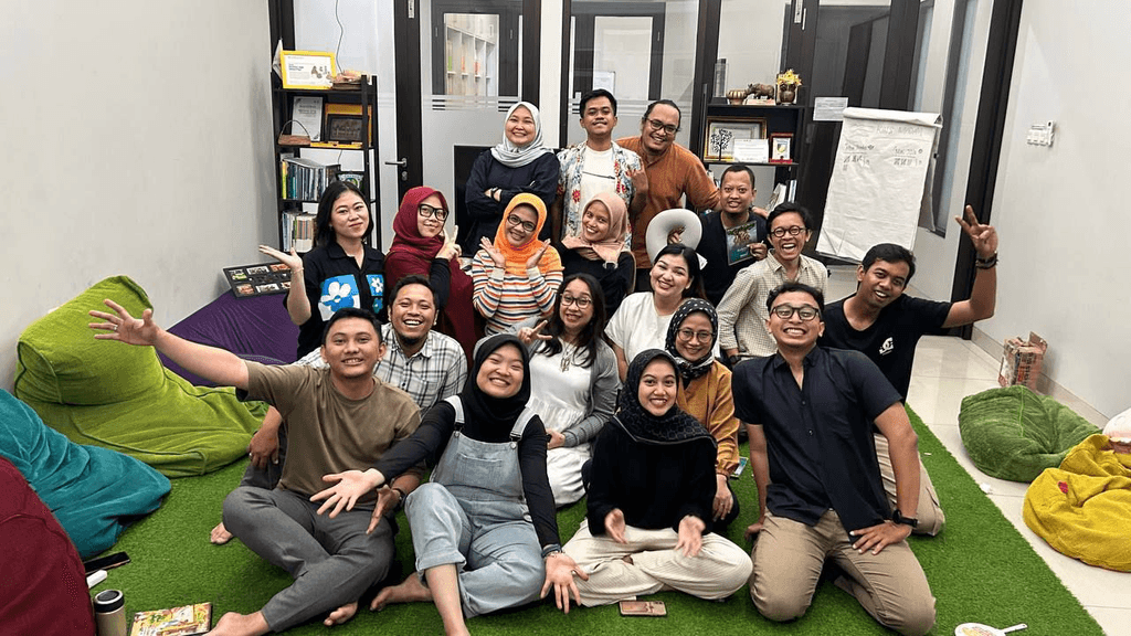 Close-up of a dark green leaf showing its textured surface and central vein against a muted background.