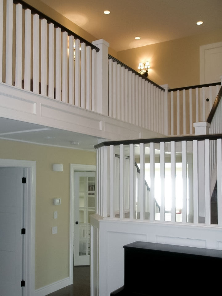 Image of Elegant interior design featuring white railings and beige walls in a KHD Homes designed home renovation.