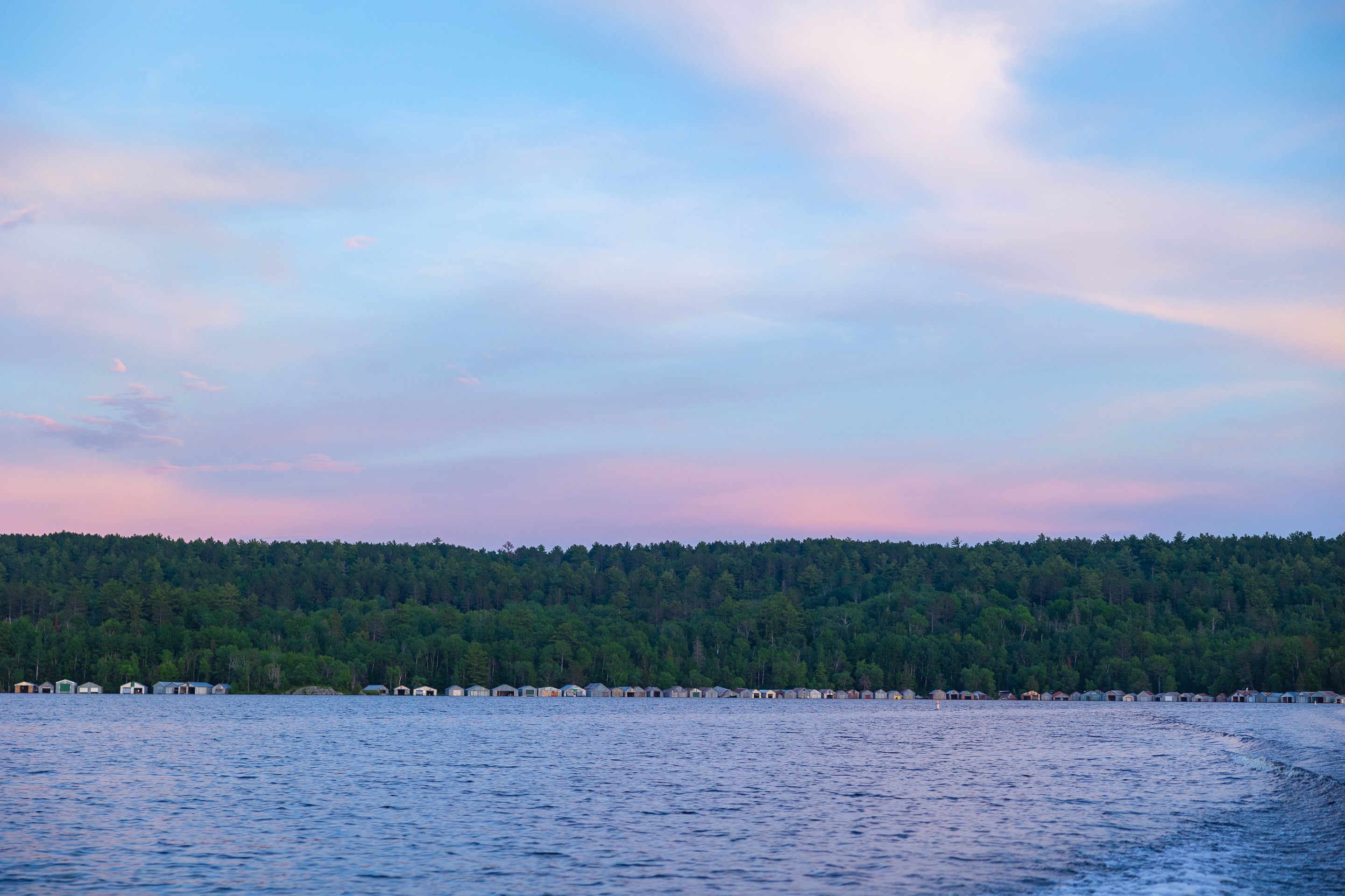 People playing soccer on a rooftop court surrounded by city buildings