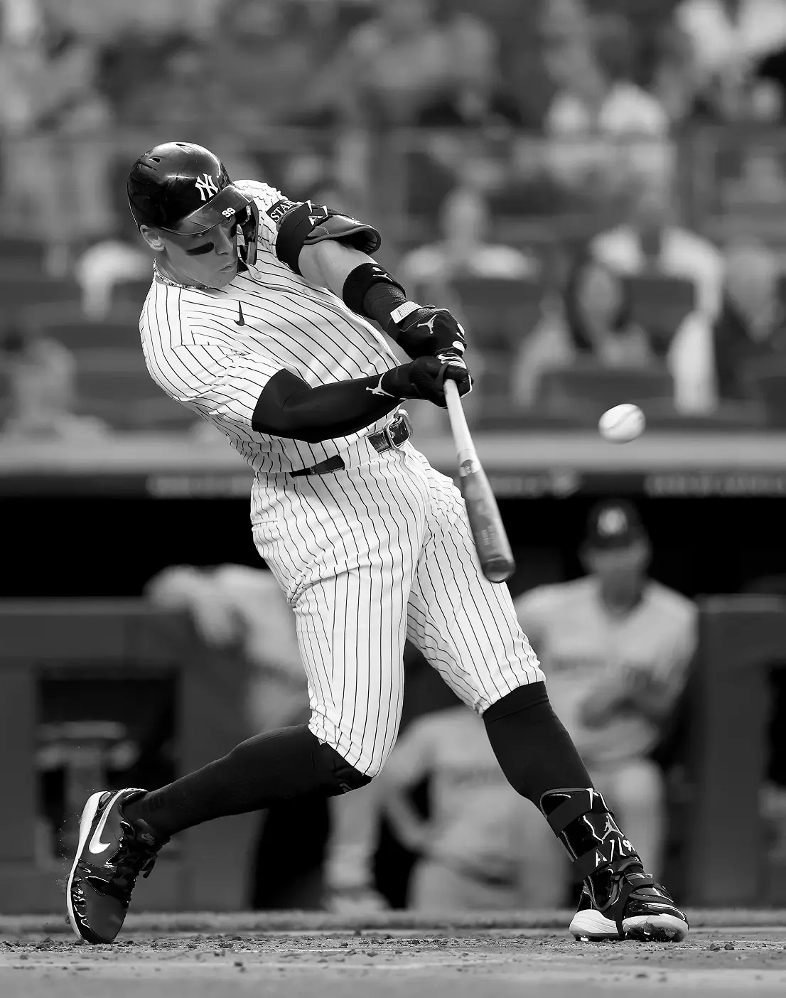 Person in hat stands by a camper van.