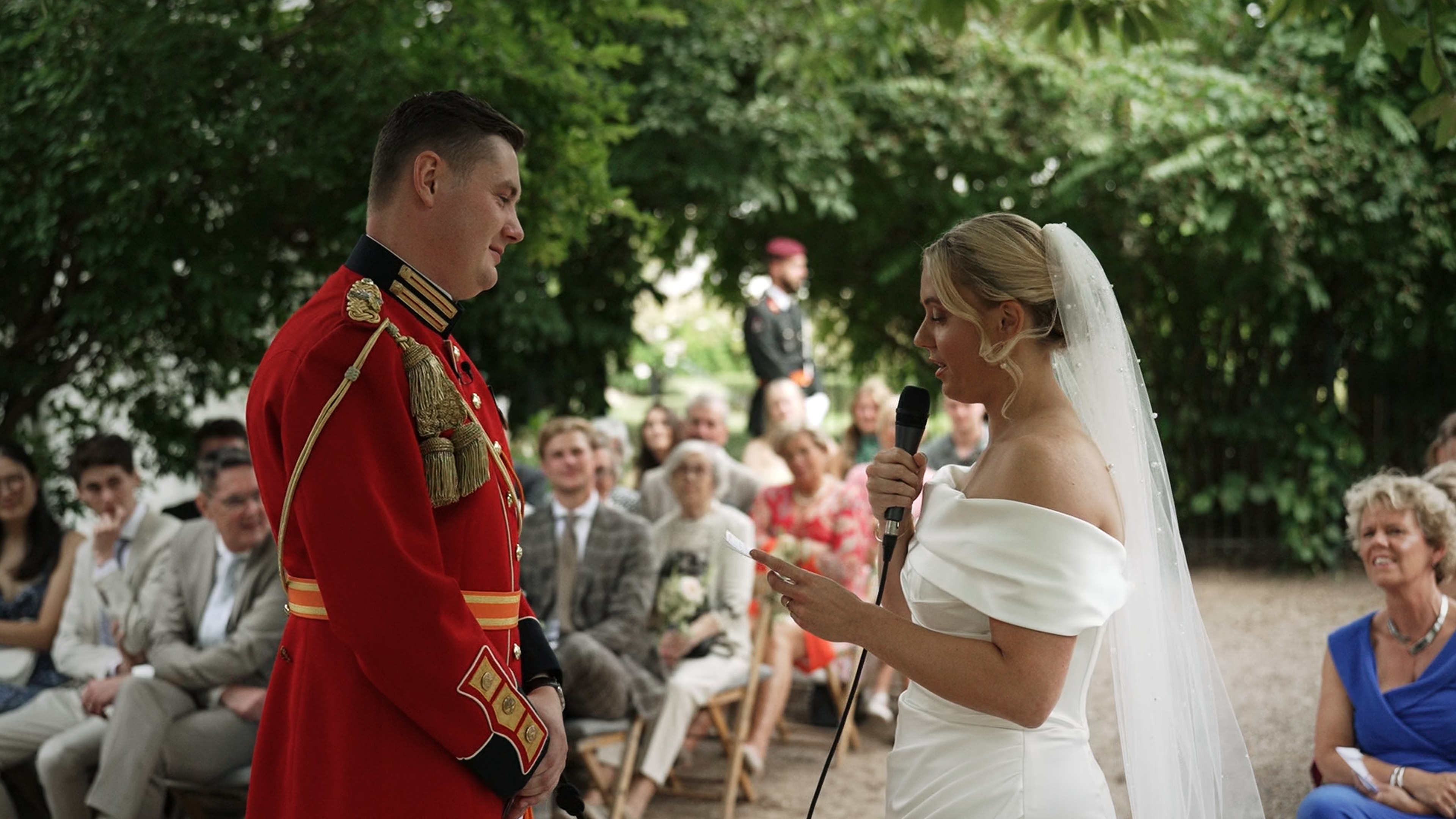 A mysteriously smiling woman covers her face with a newspaper