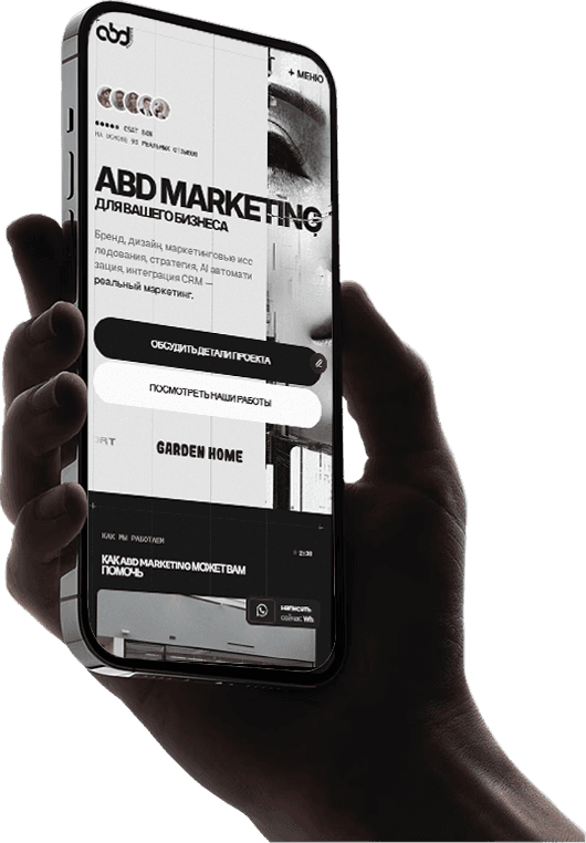 Hand holding a smartphone with a blank screen against a dark background.