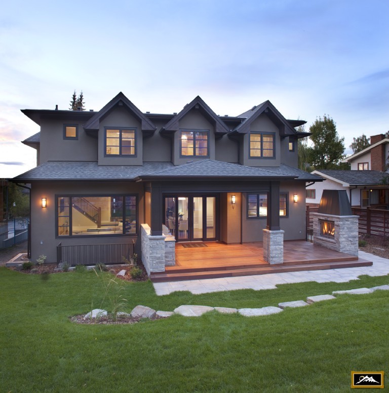 Image of Luxury home exterior with patio and fireplace, designed and built by KHD Homes for cozy living.