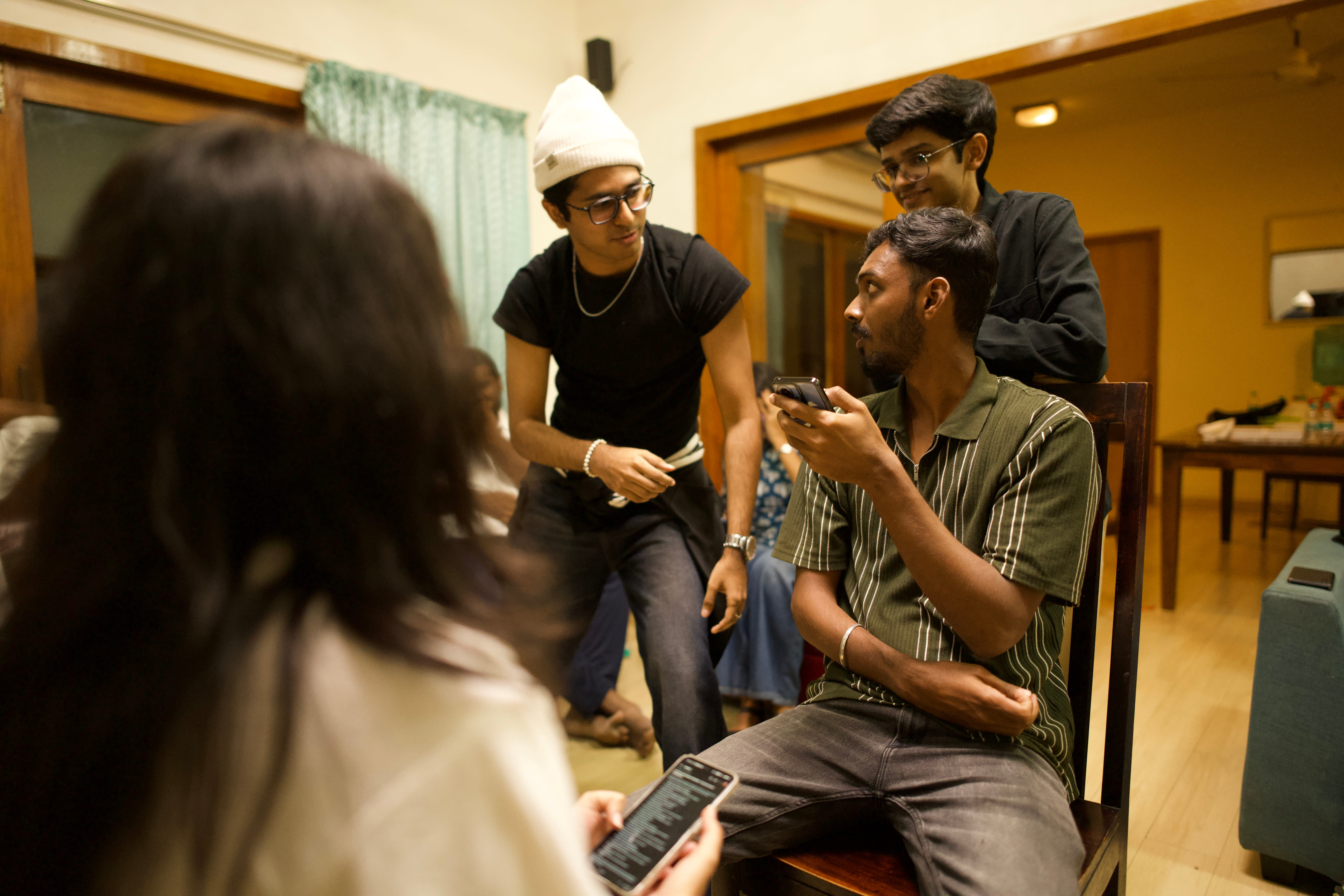 A woman in a straw hat stands in the grass