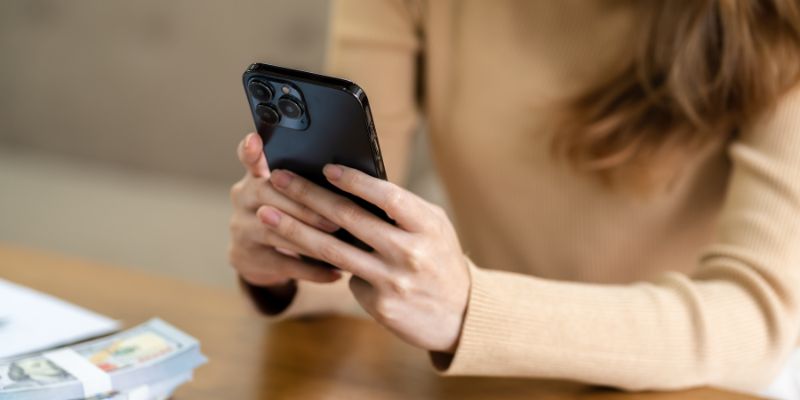 A Malaysian woman texting on her phone