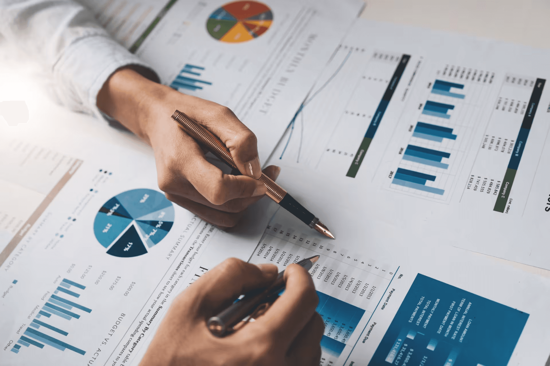High school student conducting economics research with data charts and academic journal on desk