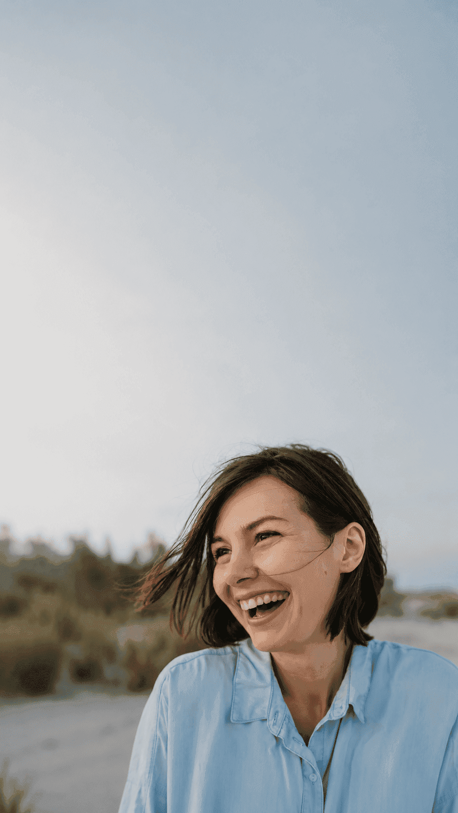 Smiling portrait candid of woman laughing