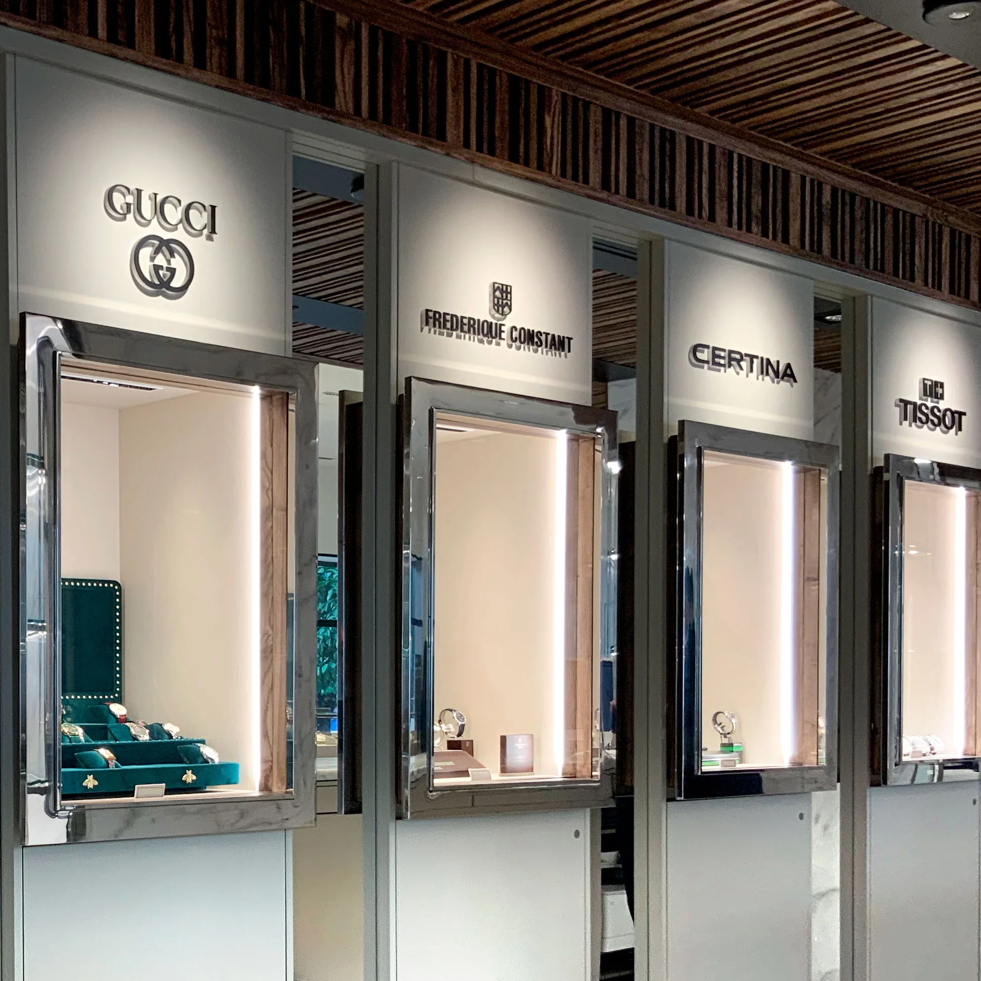 Golden cross atop a domed building with blue sky.