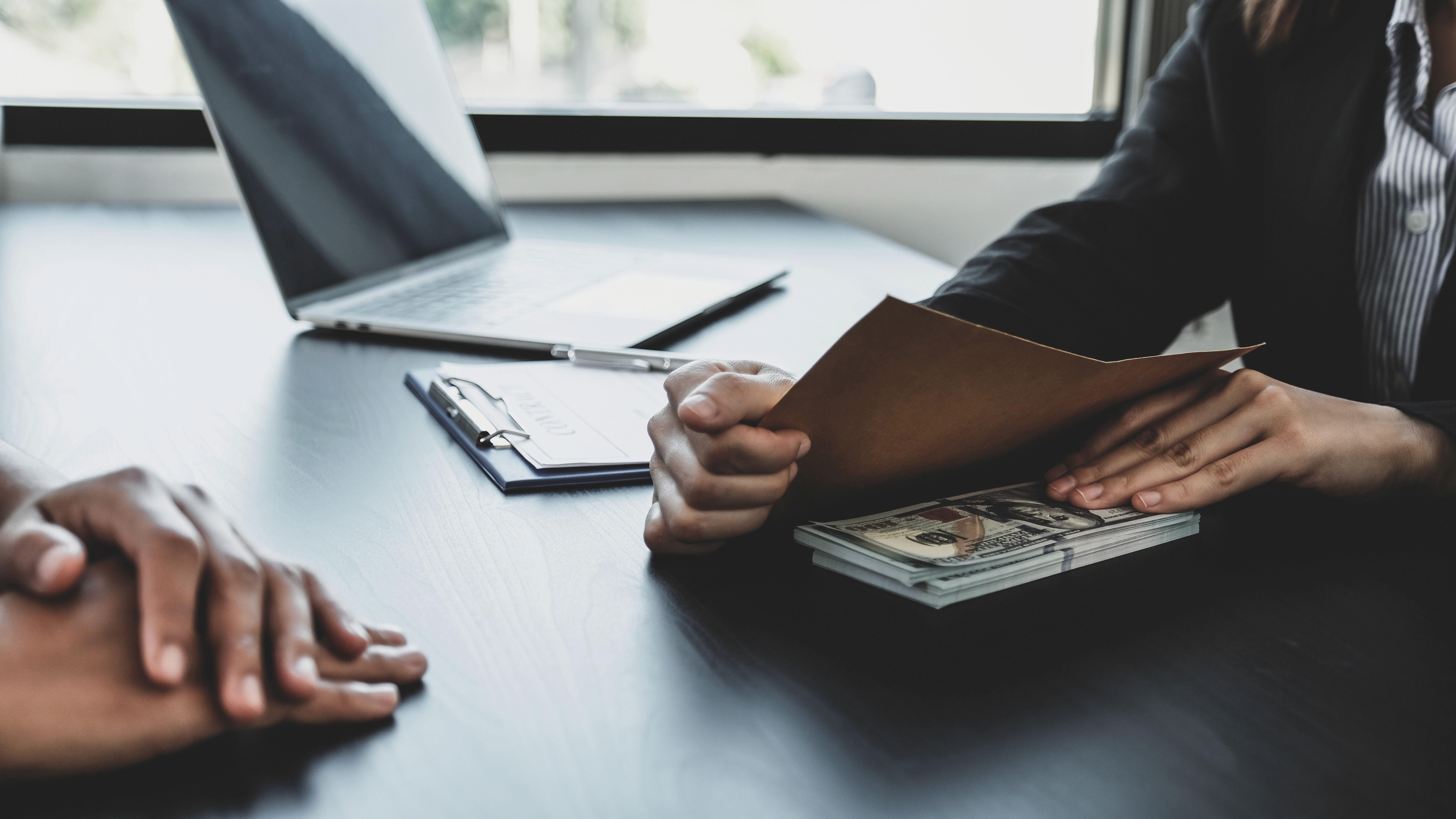 man in blue and white checkered dress shirt and black denim jeans sitting on concrete bench