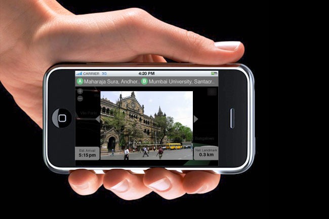 A hand holds a smartphone horizontally against a black background. The phone’s screen displays a photo of a large building with columns and trees, taken at sunset. The top of the screen shows the time as 4:20 PM and carrier as 3G. The bottom of the screen shows “Est. Arrival 5:15 pm” and “0.3 km”. The photo is credited to Maharaja Sura, Andher.