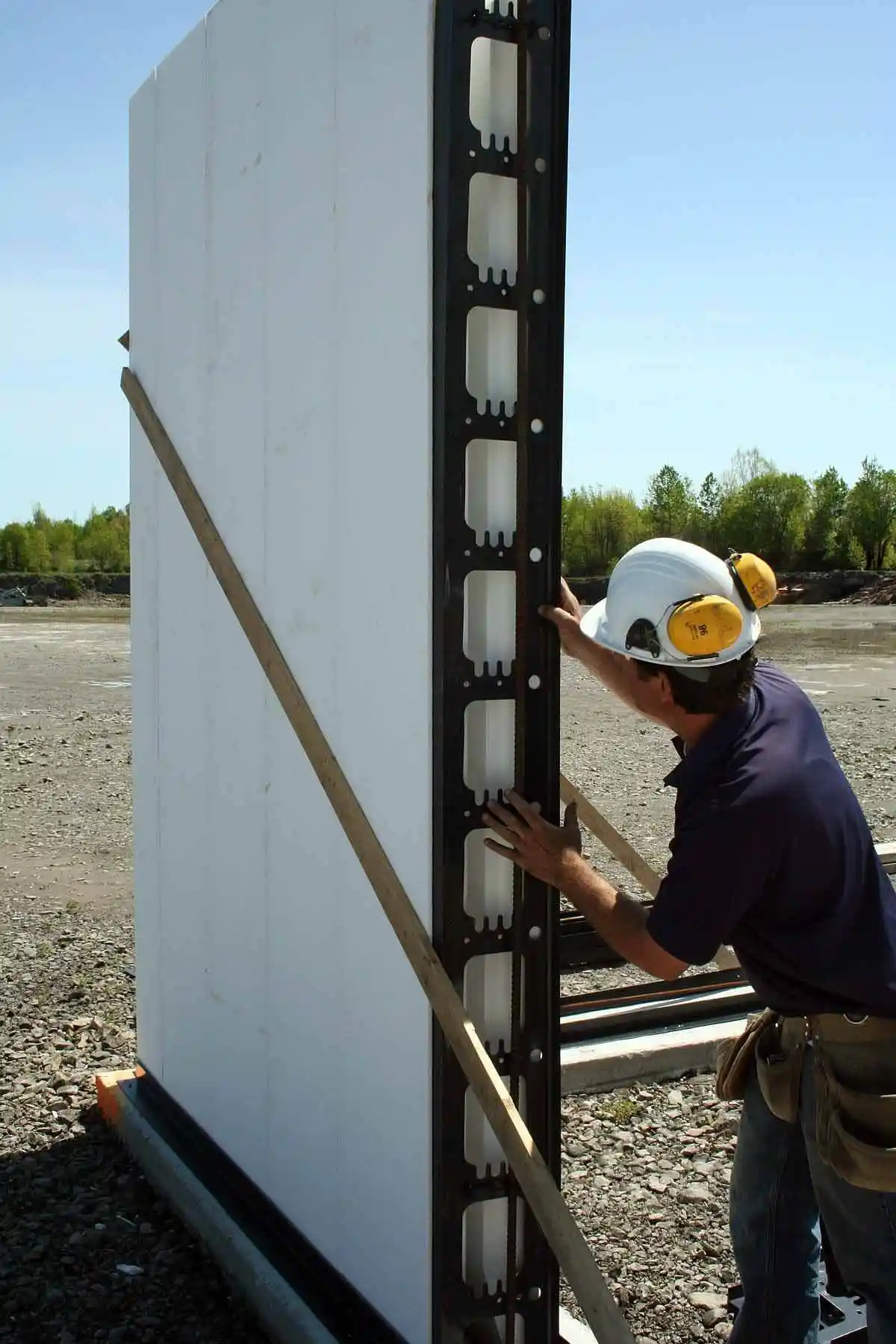 A builder erecting a foam outer wall