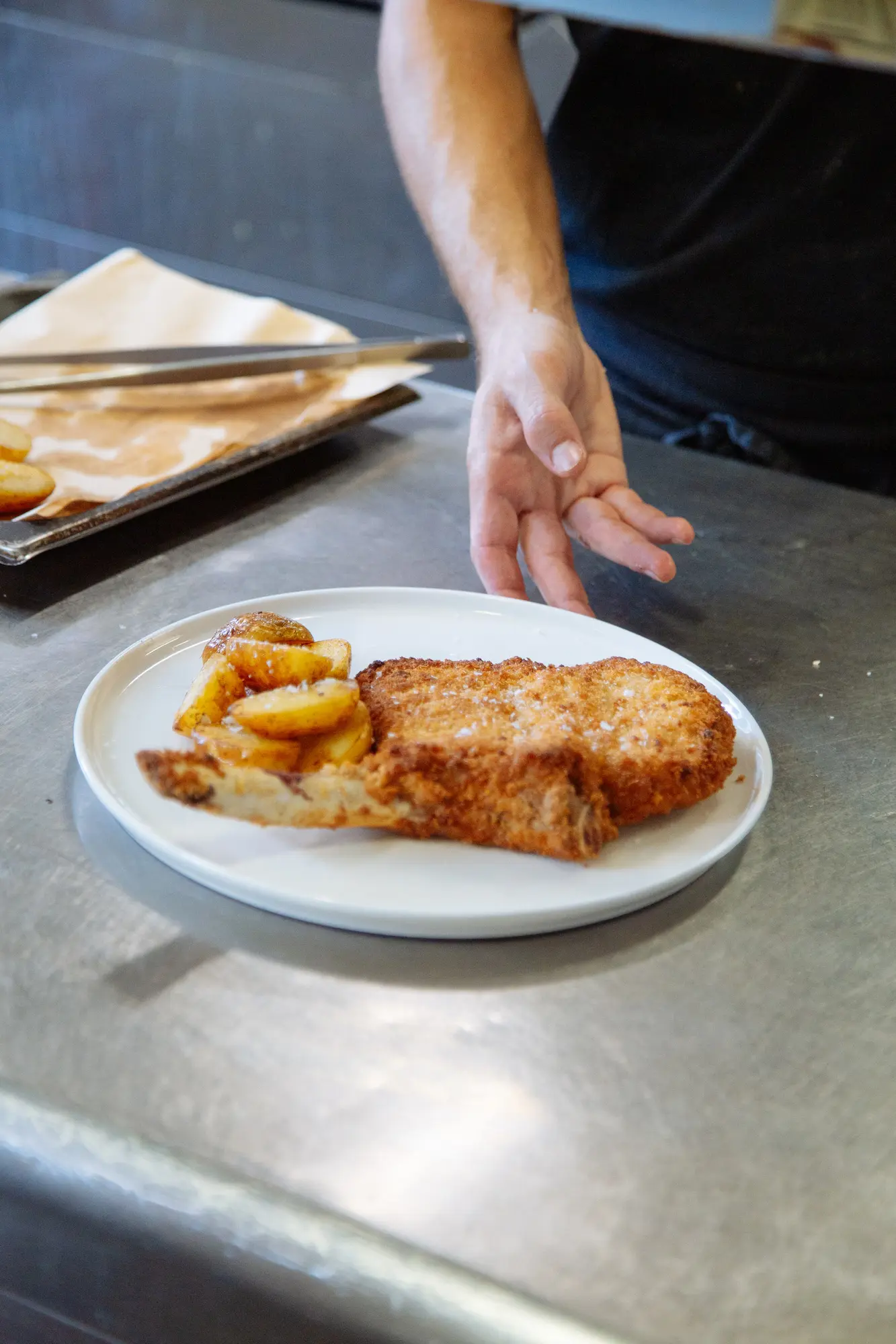 Preparazione della costoletta alla milanese nella cucina del Ristorante Unico a Cantù, specialità della tradizione lombarda.