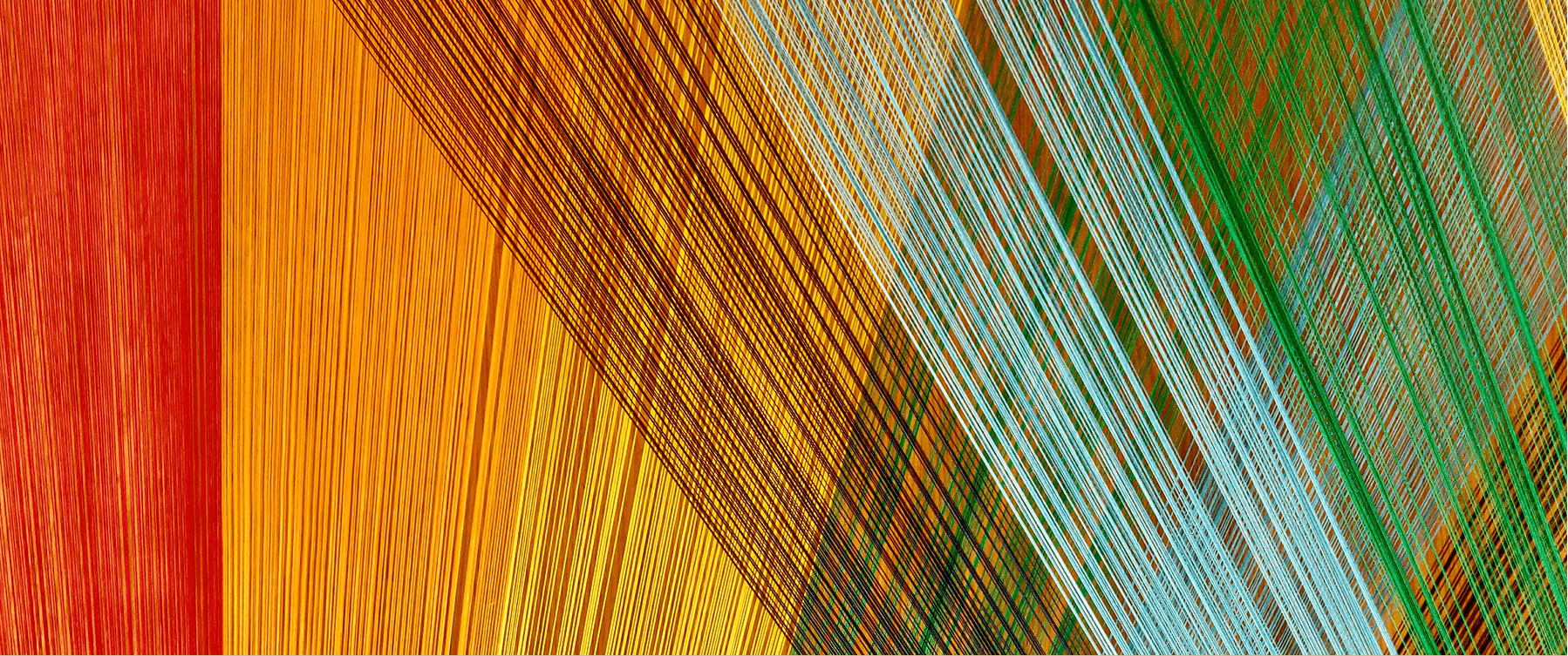 Fabric threads interwoven to create an abstract pattern