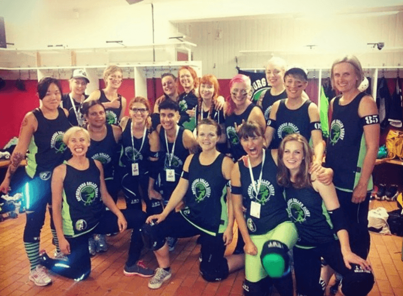 A group of roller derby players posing in front of the camera.