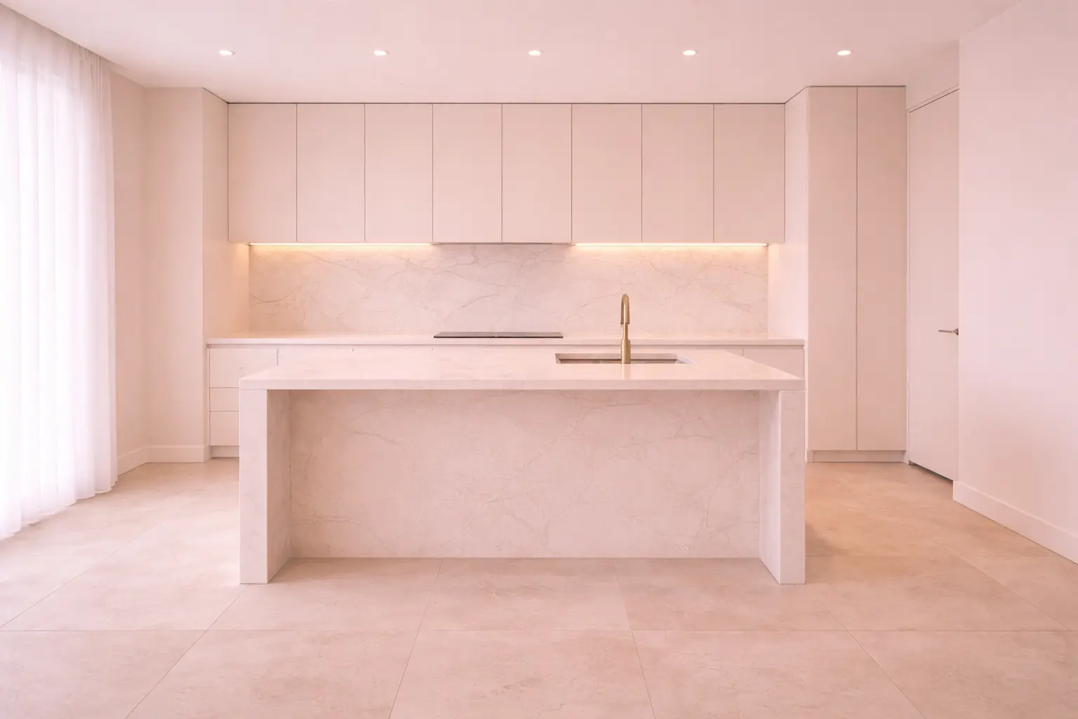 A modern, high-end kitchen after a post-construction deep clean, showing a dust-free marble waterfall island, polished cabinetry, and sanitized surfaces.