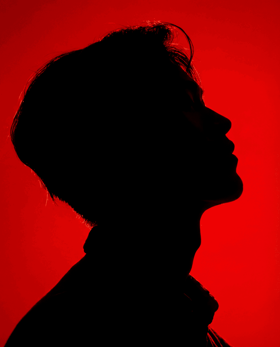 Artistic motion blur portrait of a woman in a dark room.