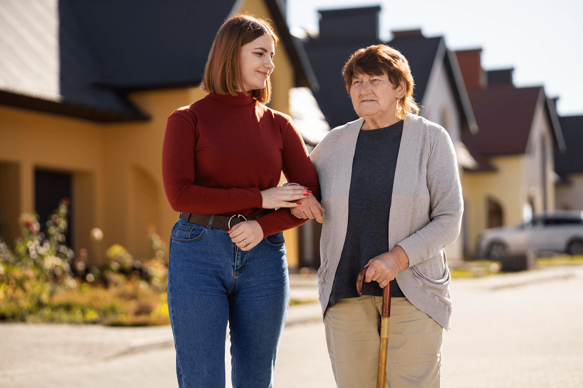 Middle-aged woman walking with older adult