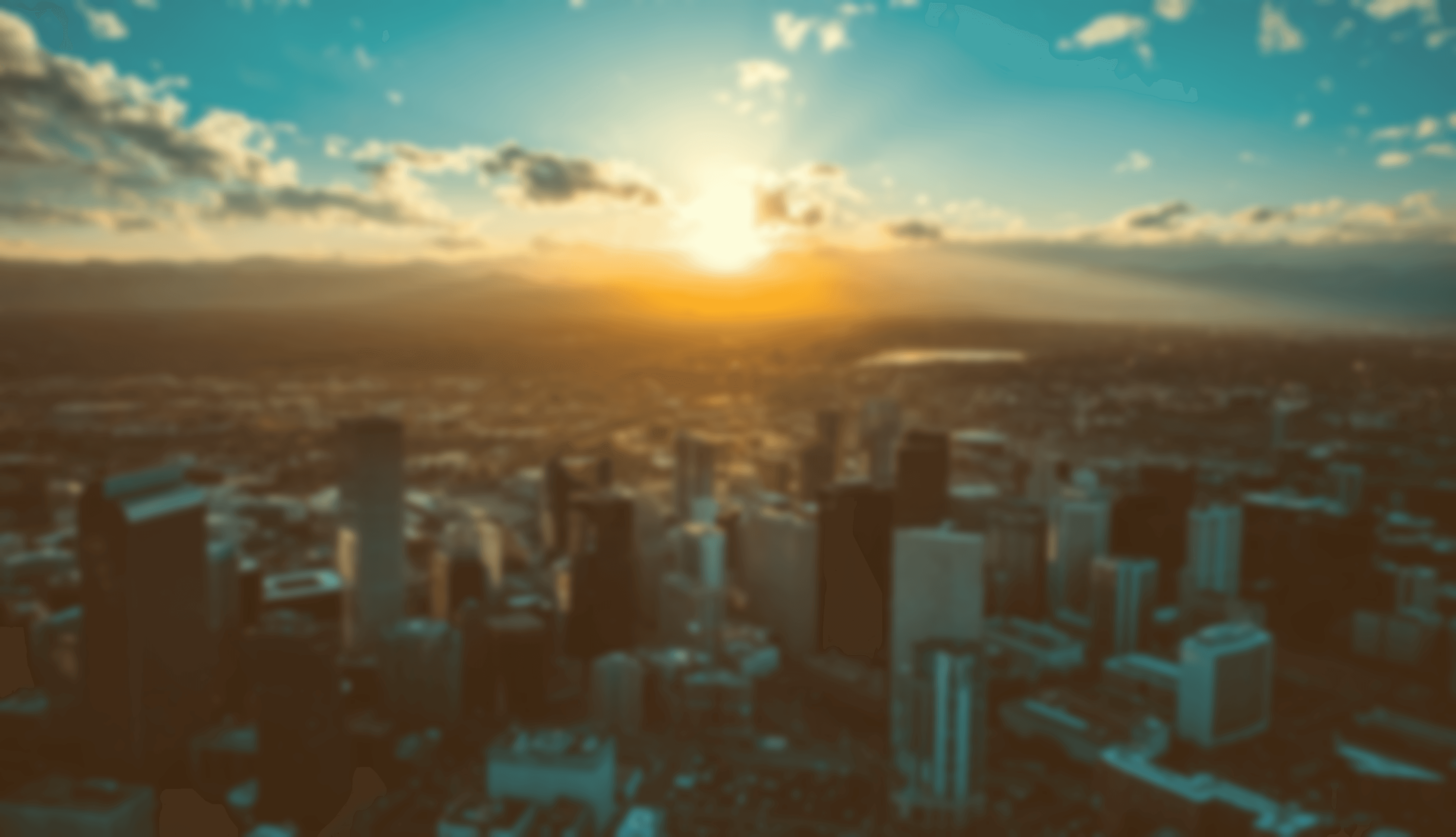 the sun is setting over a large city