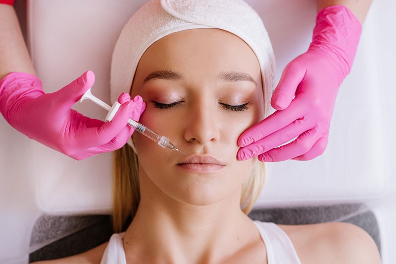 Woman applying skincare on her face