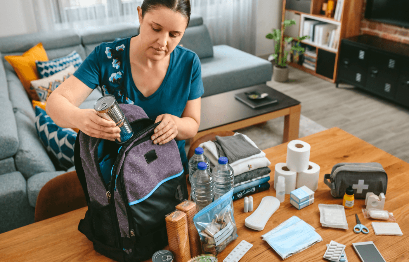 woman organizing an emergency backpack