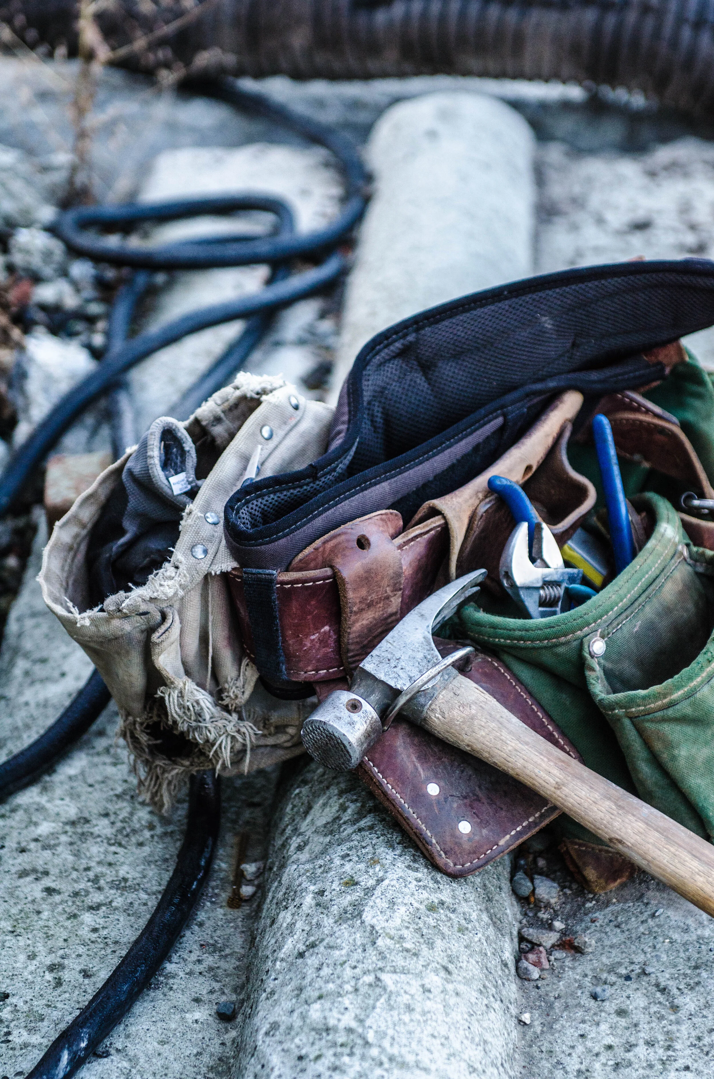 A contractor's tool belt filled with tools, representing the preparation needed for successful home renovations