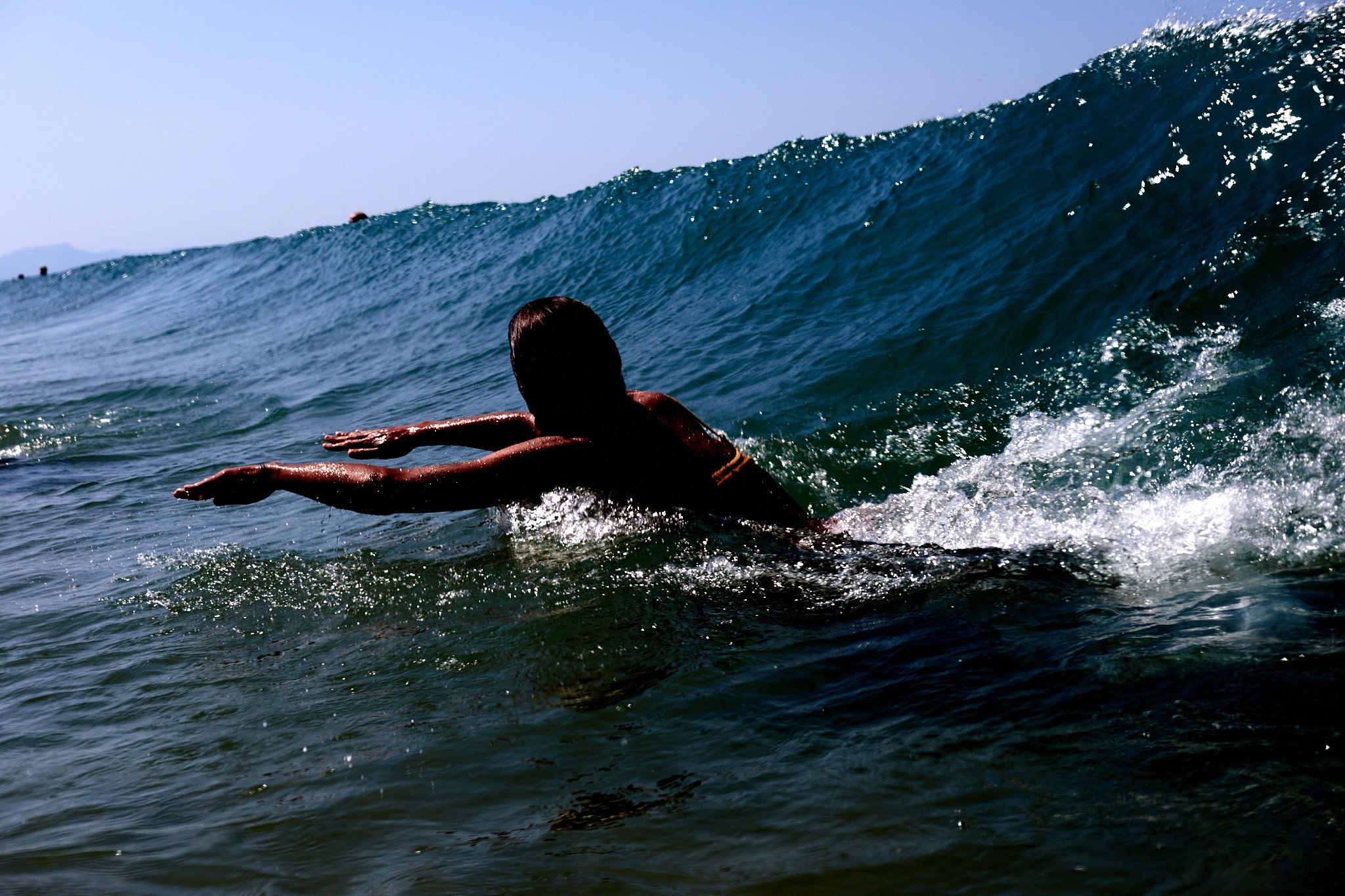 women bodysurfing in waves 