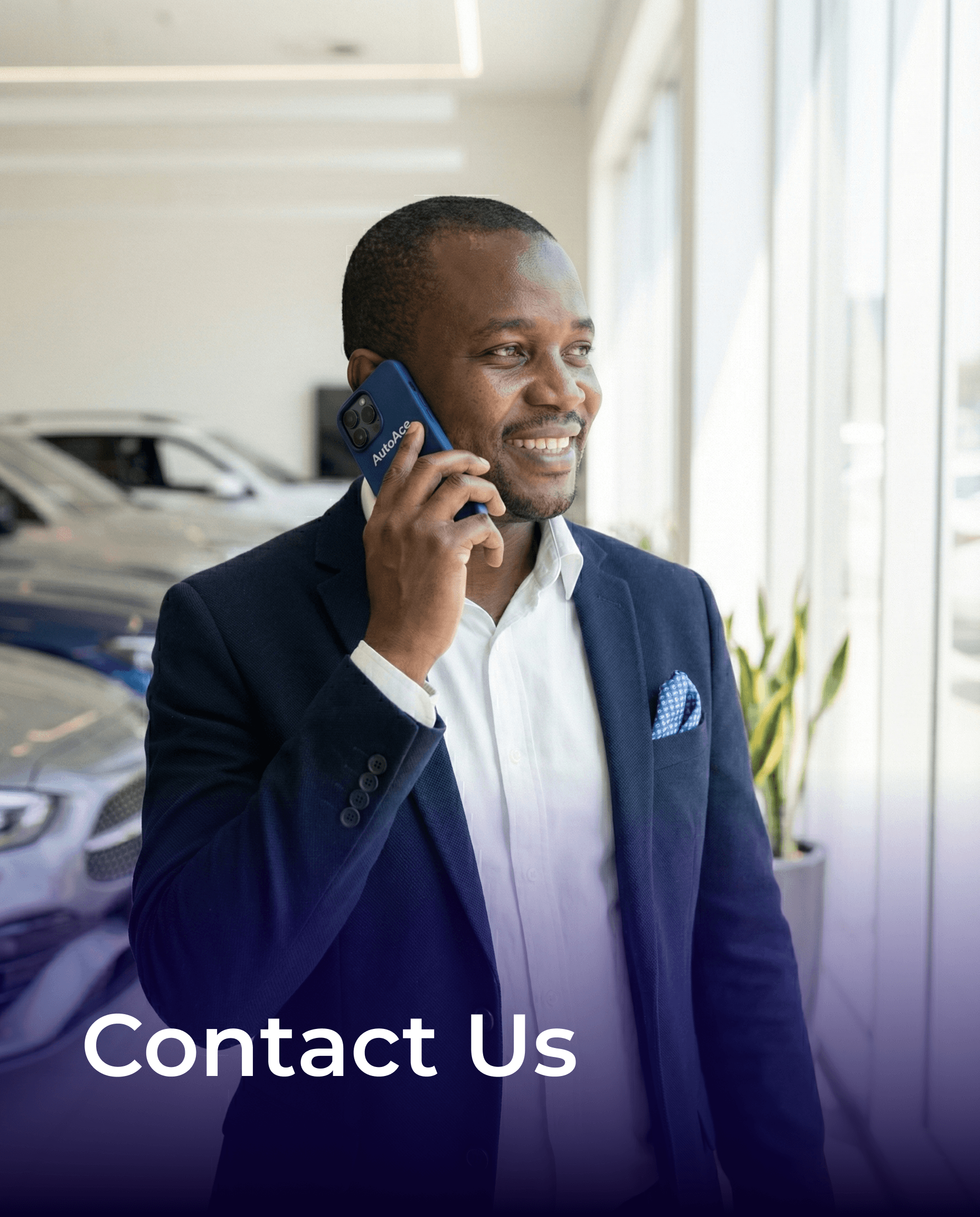 A smiling young man with crossed arms, wearing a plaid shirt and white t-shirt, poses against a dark background.