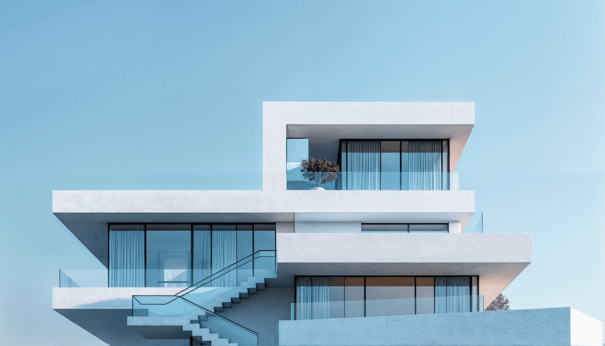 White contemporary villa with geometric balconies beneath a clear blue sky