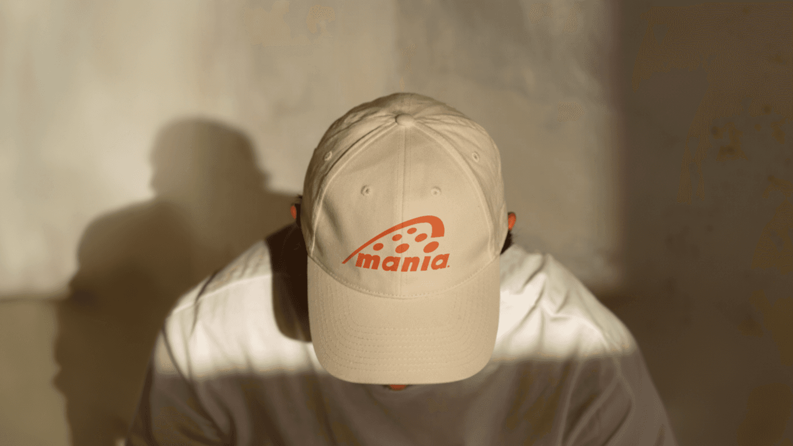 Beige Baseball cap with corlal ogo on it. a man is wearing it. 