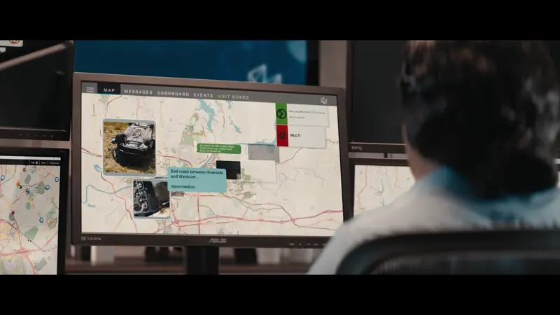 Film crew recording a studio scene with green screens and multiple monitors