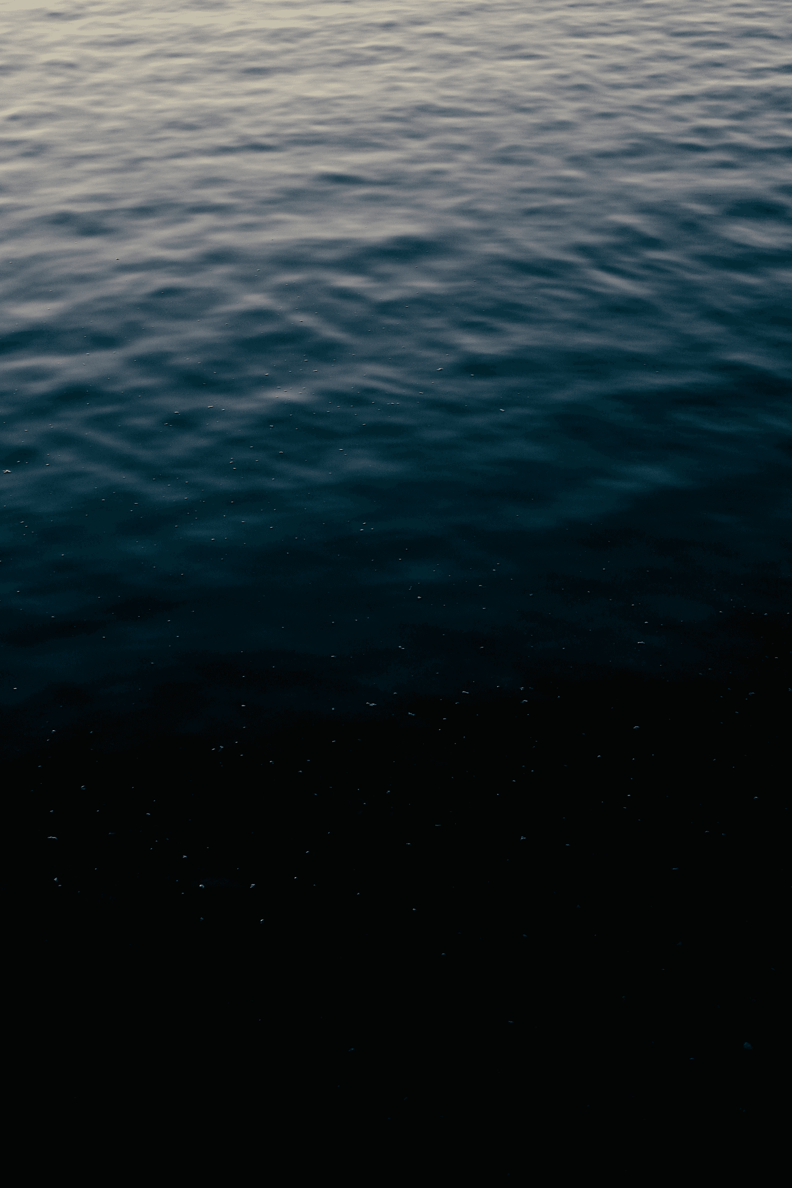 Man in dark in front of supercars.