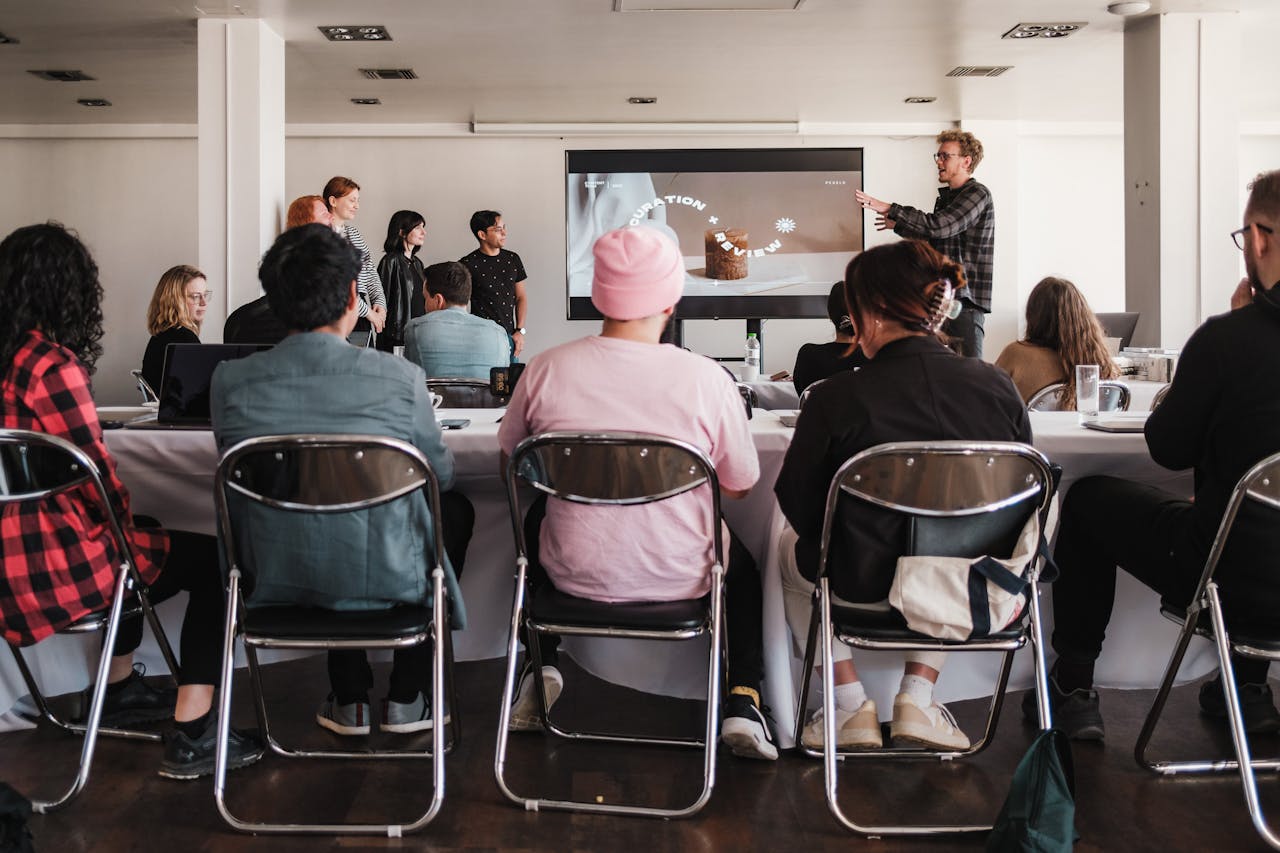 A group of people around the table with their laptops.