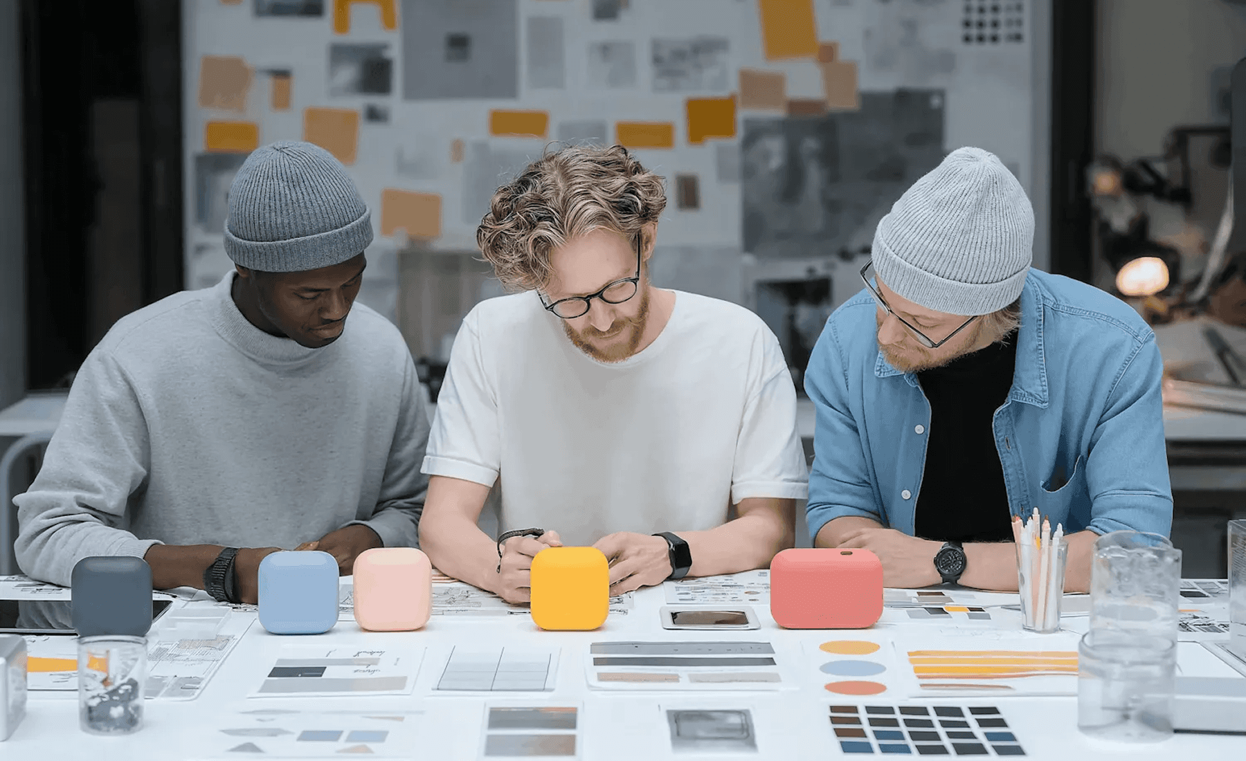 Designers working at white table.