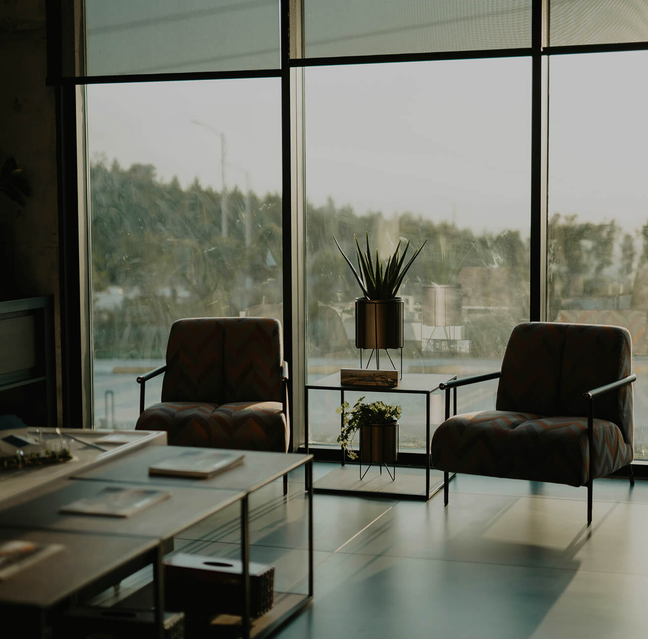 Two chairs in an office buidling with a view