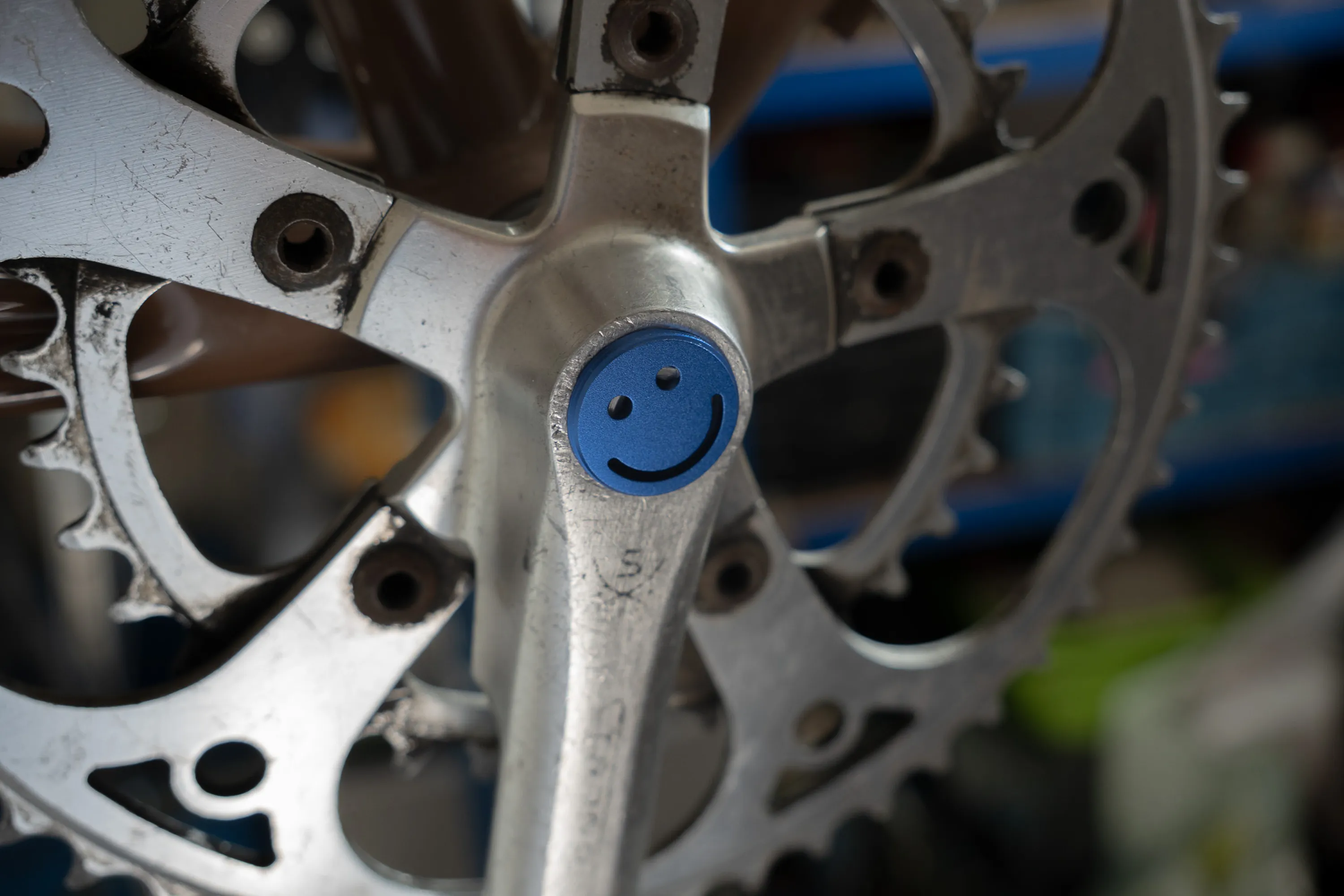A close up of a person working on a bike crankset