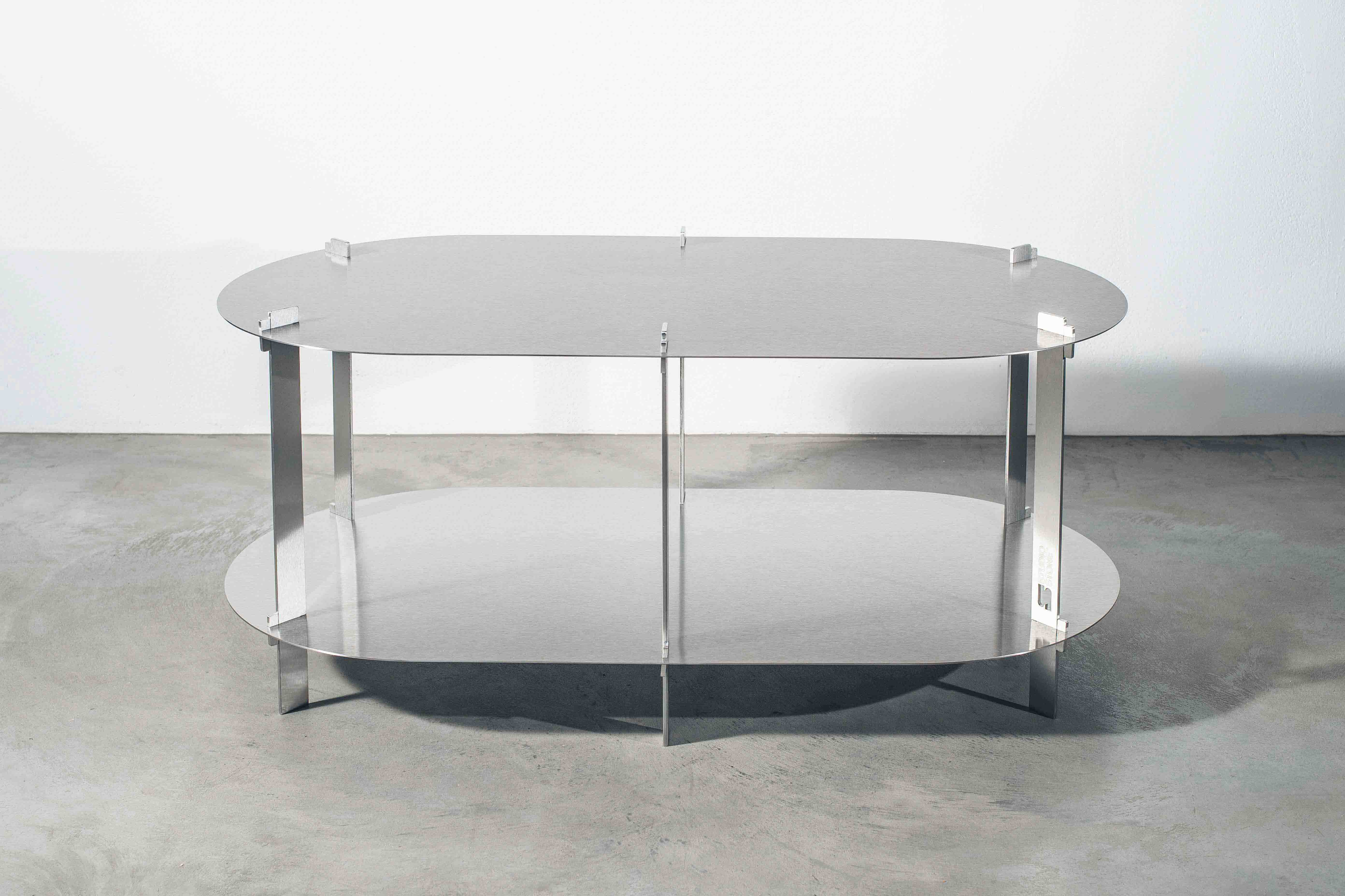 a metal designer table on a concrete floor